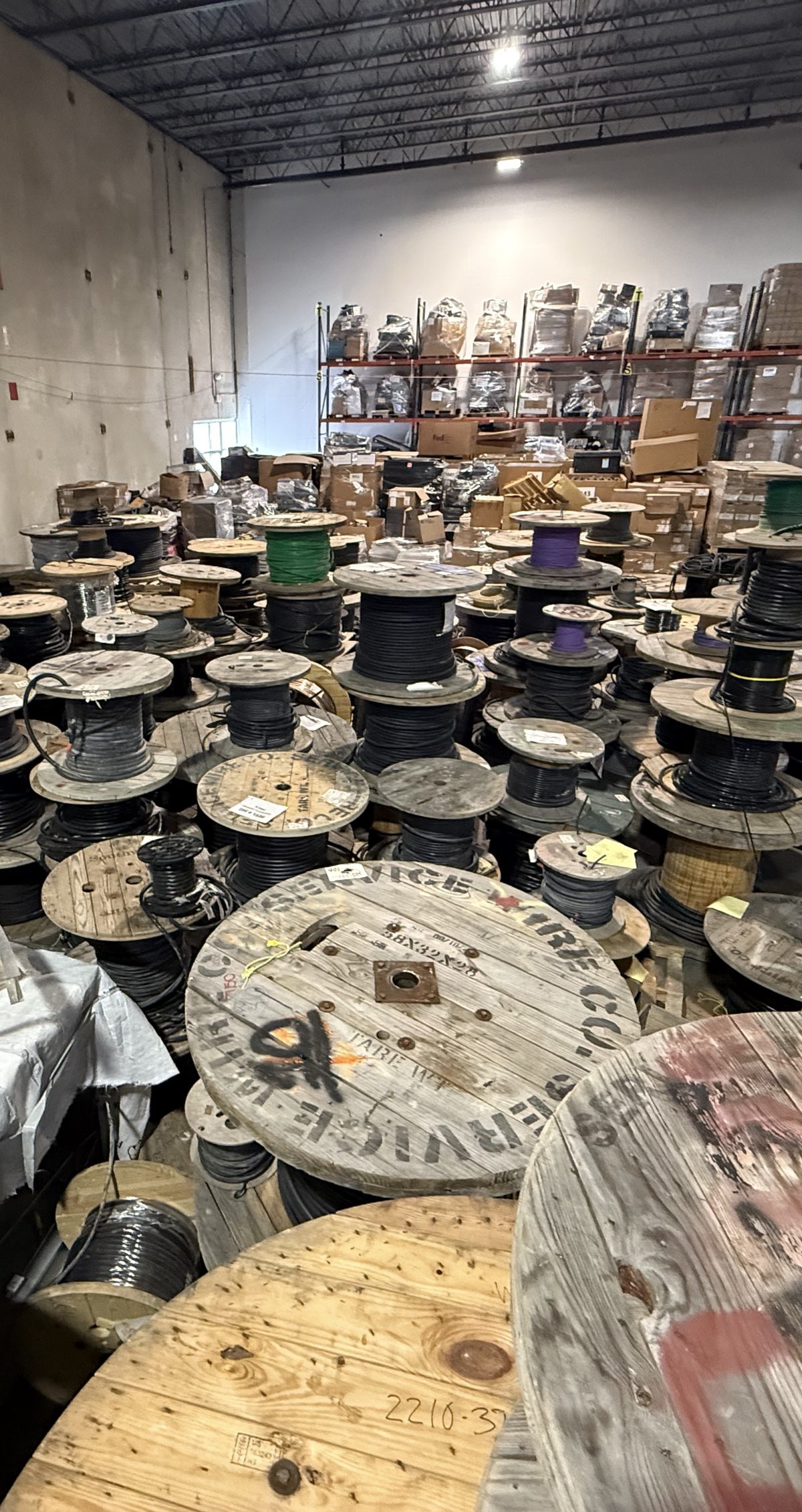 Warehouse full of surplus electrical wire spools purchased by Electrical Wire Buyers